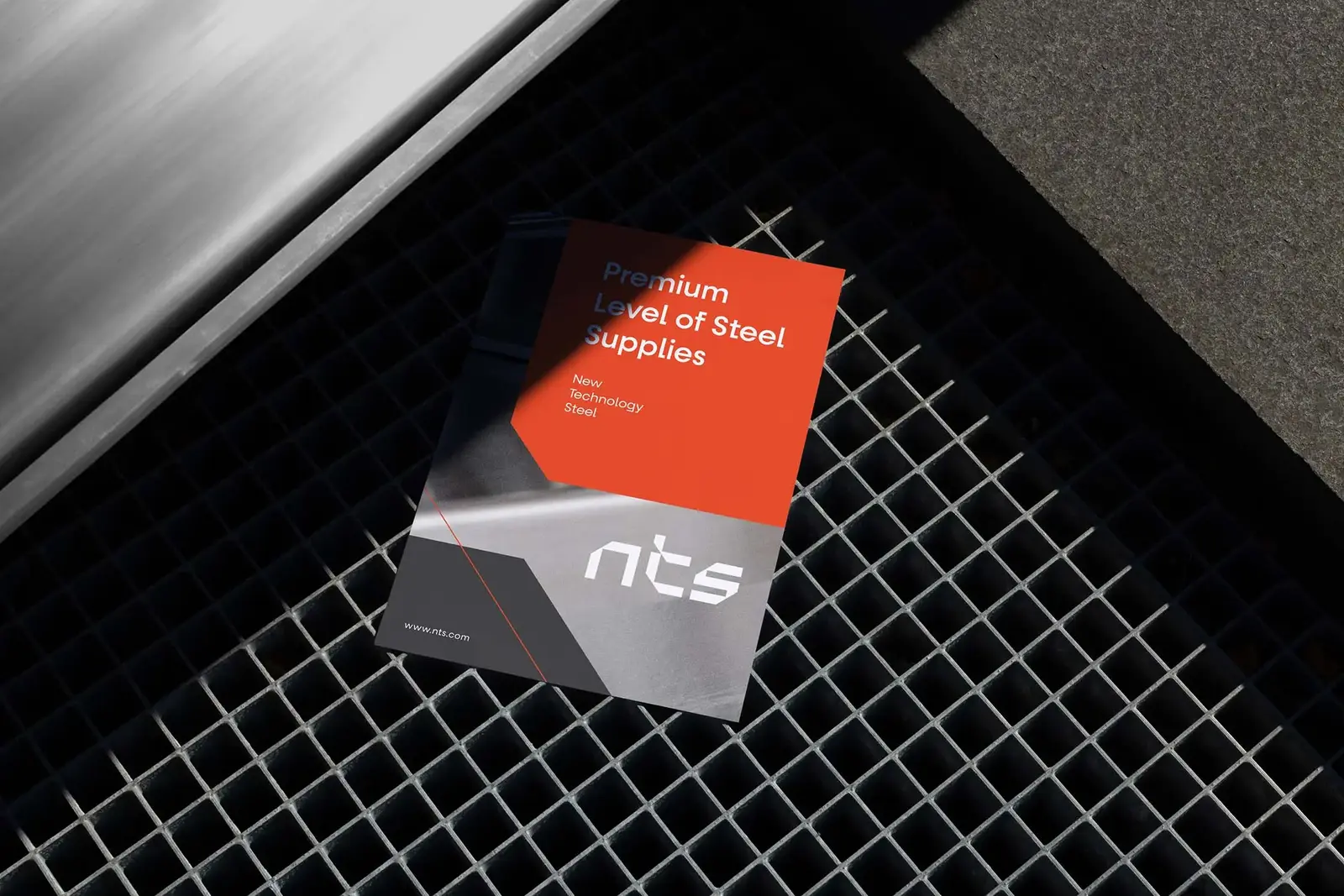 NTS flyer with the headline Premium Level of Steel Supplies and the new white wordmark, lying on a steel grate