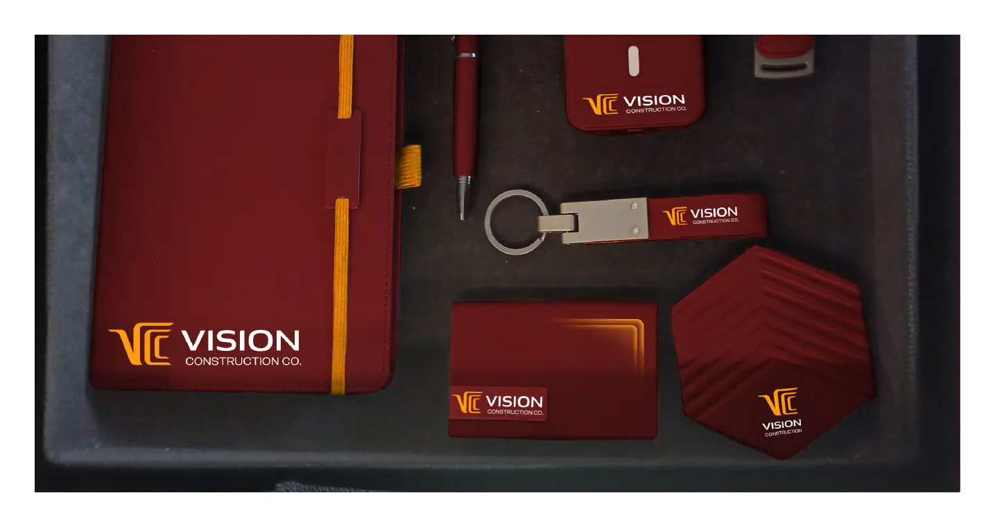VCC VIP gift kit in dark red: notebook, pen, power bank, keychain and coasters in a black case