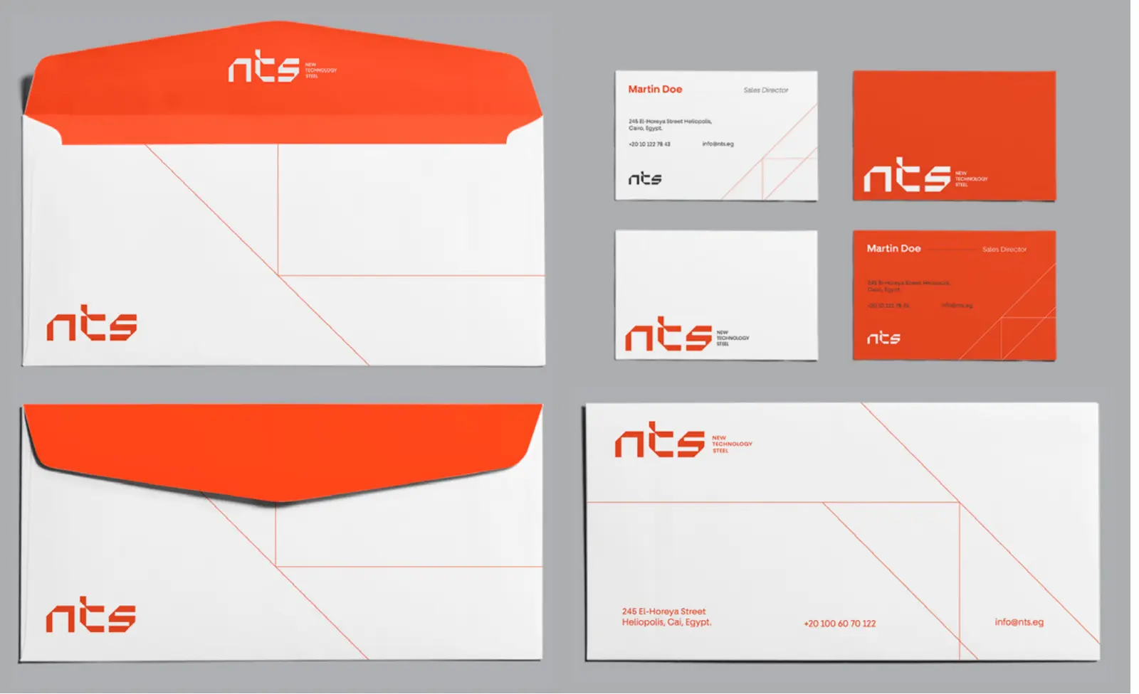 NTS envelopes and business cards in orange and white, crossed by thin 45-degree lines