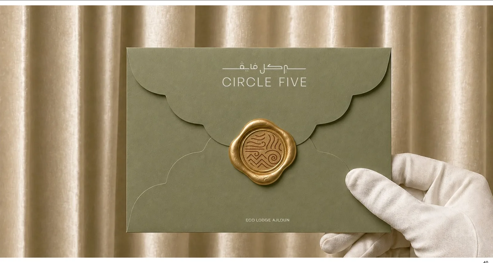 Circle Five hotel stationery: sage green envelope with a gold wax seal of the five elements symbol
